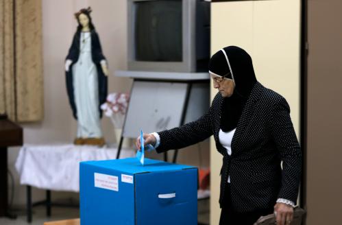 An Israeli Arab casts her ballot at a polling station inside a church in the northern town of Reineh March 17, 2015.  Prime Minister Benjamin Netanyahu faced a fight for his political survival on Tuesday as Israelis voted in an election that opinion polls predict the centre-left opposition could win. REUTERS/Ammar Awad (ISRAEL - Tags: POLITICS ELECTIONS) - GM1EB3I09JH01