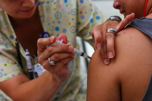 A teenager receives a tetanus vaccination at the Remote Area Medical and Operation Lone Star joint health clinic at Palmview High School in Mission, Texas August 5, 2014.  Operation Lone Star started 16 years ago to help the guard prepare for emergencies such as hurricanes or pandemics in south Texas. Since then it has expanded its medical care component, treating thousands in a region that hugs the Mexican border, including some who come because no identification papers are required. Picture taken August 5, 2014. REUTERS/Shannon Stapleton (UNITED STATES - Tags: SOCIETY HEALTH POLITICS) - GM1EA8F0FWG01