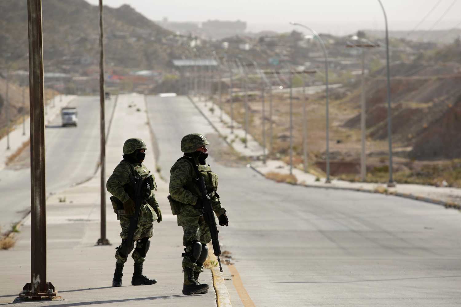 DATE IMPORTED: March 15, 2019. Soldiers keep watch near a crime scene where the bodies were left by unknown assailants, on the outskirts of Ciudad Juarez, Mexico March 15, 2019. REUTERS/Jose Luis Gonzalez