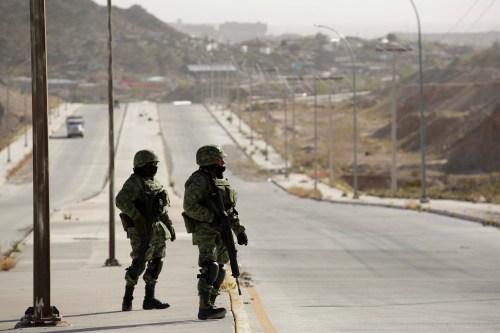 DATE IMPORTED: March 15, 2019. Soldiers keep watch near a crime scene where the bodies were left by unknown assailants, on the outskirts of Ciudad Juarez, Mexico March 15, 2019. REUTERS/Jose Luis Gonzalez