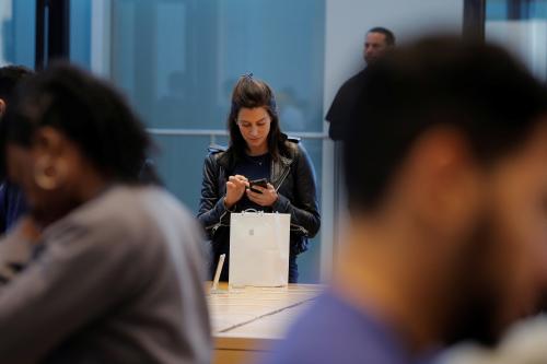 A woman looks at her Apple iPhone X at an Apple store in New York, U.S., November 3, 2017.  REUTERS/Lucas Jackson - RC1AE432FB10
