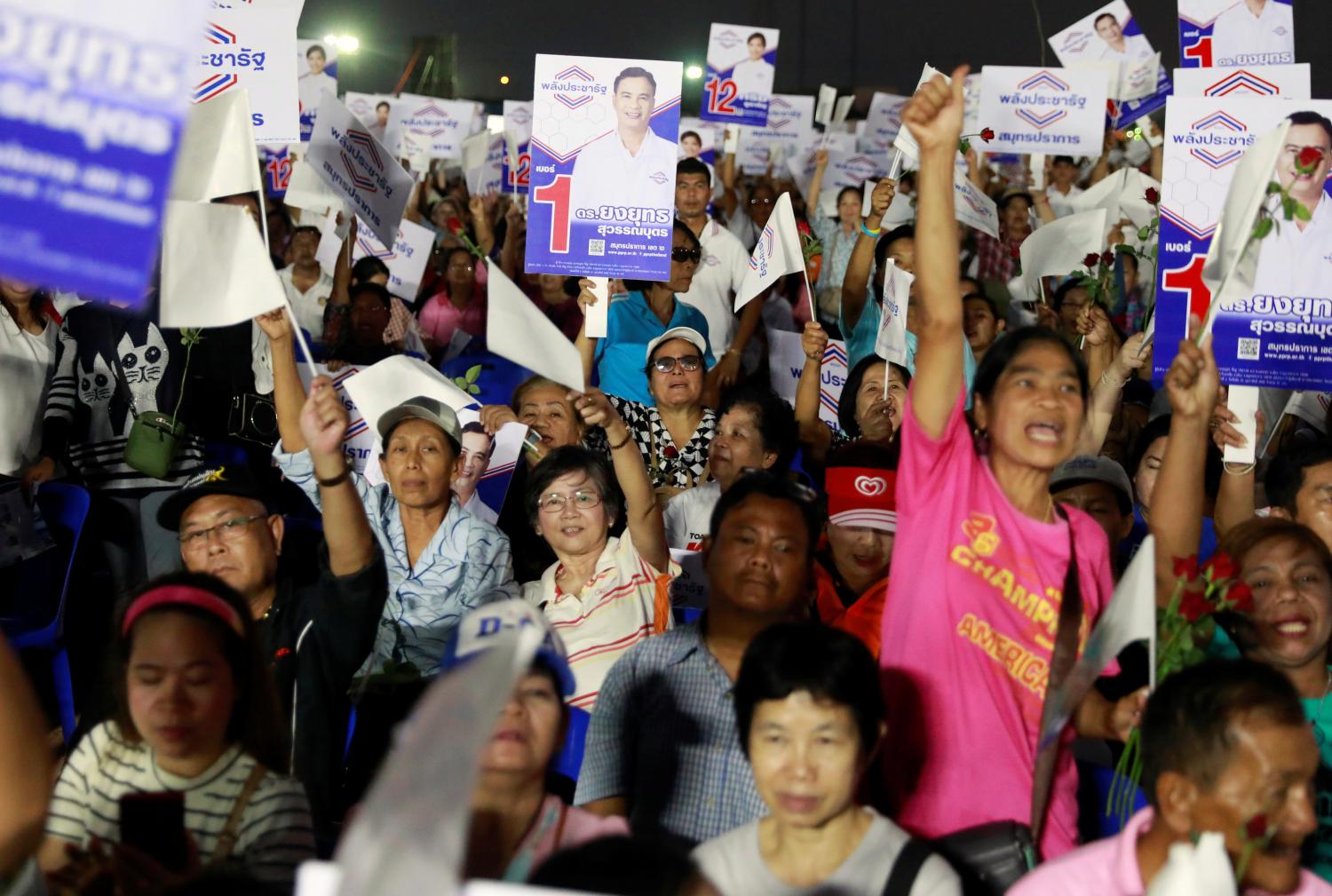 Supporters hold up signs during the Palang Pracharat Party campaign rally in Bangkok, Thailand, February 24, 2019. Picture taken February 24, 2019. REUTERS/Soe Zeya Tun - RC163BF7AD00