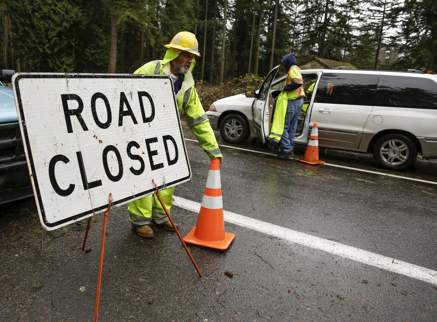 Workers keep a portion of Issaquah-Hobart Road Southeast closed to traffic as crews restore a damaged power pole in Issaquah, Washington December 10, 2015. Residents of the U.S. Pacific Northwest were hit by fresh storms on Thursday after the region received record-breaking rainfall that left two dead in Oregon and triggered widespread flooding, landslides, road closures and power cuts. REUTERS/Jason Redmond - GF10000261699