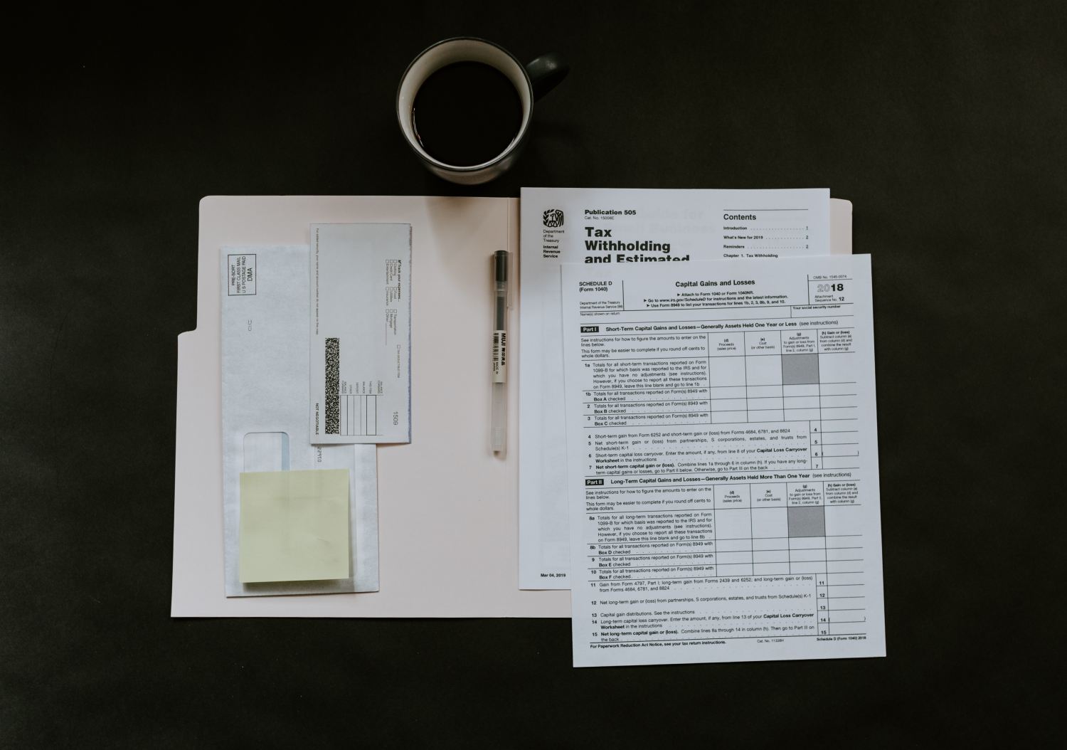 Photo of tax paperwork. By Kelly Sikkema on Unsplash