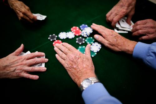 Retirees play poker at a singles club in Sun City, Arizona, January 4, 2013. Sun City was built in 1959 by entrepreneur Del Webb as America?s first active retirement community for the over-55's. Del Webb predicted that retirees would flock to a community where they were given more than just a house with a rocking chair in which to sit and wait to die. Today?s residents keep their minds and bodies active by socializing at over 120 clubs with activities such as square dancing, ceramics, roller skating, computers, cheerleading, racquetball and yoga. There are 38,500 residents in the community with an average age 72.4 years. Picture taken January 4, 2013. REUTERS/Lucy Nicholson (UNITED STATES - Tags: SOCIETY)ATTENTION EDITORS - PICTURE 8 OF 30 FOR PACKAGE 'THE SPORTY SENIORS OF SUN CITY'SEARCH 'SUN CITY' FOR ALL IMAGES - GM1E91H00QW01