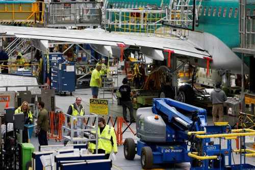 Employees work on several 737 Max aircrafts at the Boeing factory in Renton, Washington, U.S., March 27, 2019.  REUTERS/Lindsey Wasson - RC12CF24E470