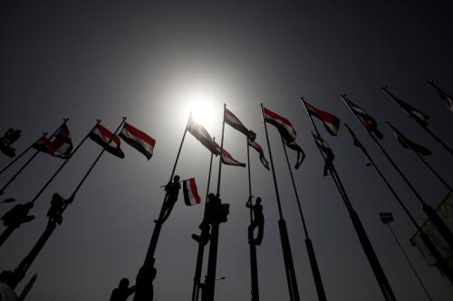 People climb flag poles flying Yemen's national flag during a ceremony marking Yemen's Reunification Day, in Sanaa, May 22 ,2016. REUTERS/Mohamed al-Sayaghi - S1BETFMQVRAB