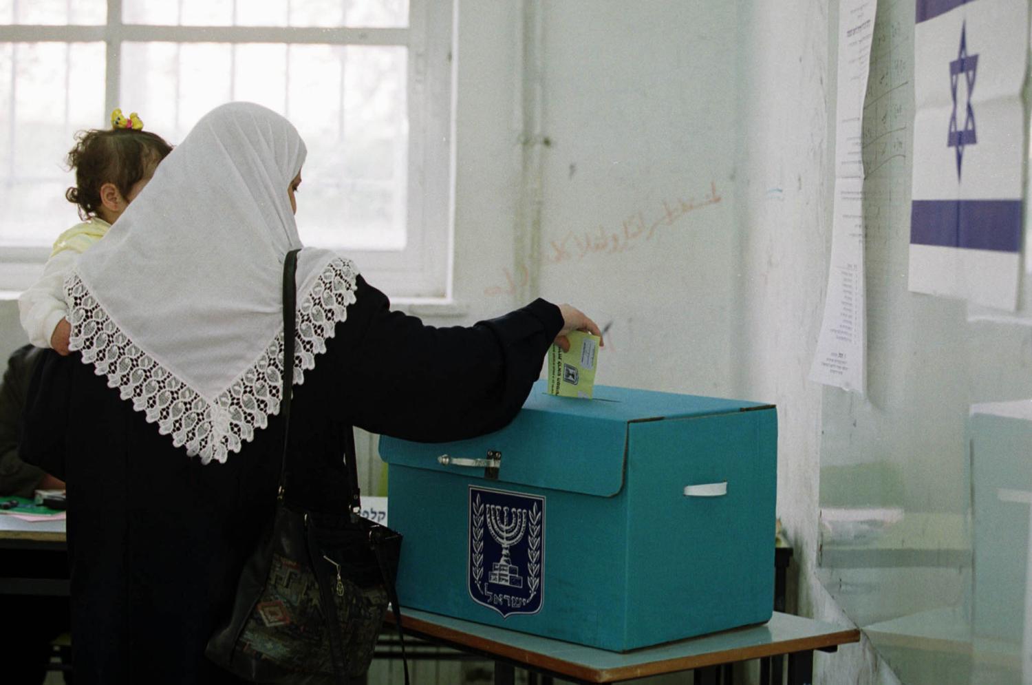 An Israeli-Arab voter drops a ballot into a ballot box during voting in East Jerusalem, February 6, 2001. Most Israeli-Arabs are expected to abstain from voting in a protest against the 13 Israeli-Arabs who were killed during the recent 'Intifada' or uprising against Israel. Ariel Sharon appeared poised for a stunning political victory over Prime Minister Ehud Barak as voters began casting ballots Tuesday in an election seen as a referendum on Israel's relationship with the Palestinians.EH/WS - RP2DRIGVXBAA