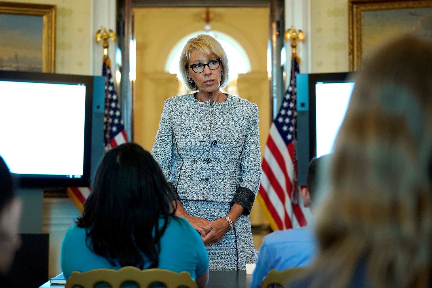 U.S. Secretary of Education Betsy DeVos speaks with school children during a listening session before the arrival of U.S. first lady Melania Trump at the White House in Washington, U.S., April 9, 2018. REUTERS/Joshua Roberts - RC14E35B0270