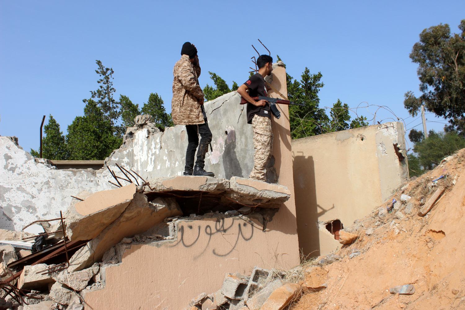 Members of the Libyan internationally recognised government forces look out from a destroyed building at Khallat Farjan area in Tripoli, Libya April 20, 2019. REUTERS/Ayman al-Sahili - RC19CE00E4B0