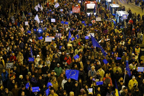 People carry European Union flags during a protest ahead of a visit by Russian President Vladimir Putin, in Budapest February 16, 2015. Putin will discuss Russian gas supplies to Hungary when he visits Budapest on Tuesday, an adviser to the Russian president said on Monday. The trip will be Putin's first bilateral visit to a European Union country since June 2014, reflecting a warming in ties that has irked some of Hungary's allies in the EU and NATO. REUTERS/Laszlo Balogh (HUNGARY  - Tags: POLITICS CIVIL UNREST)   - LR2EB2G1H542J