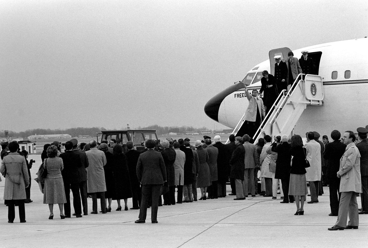 Recently freed Americans held hostage by Iran disembark Freedom One, an Air Force VC-137 Stratoliner aircraft, upon their arrival at the base.