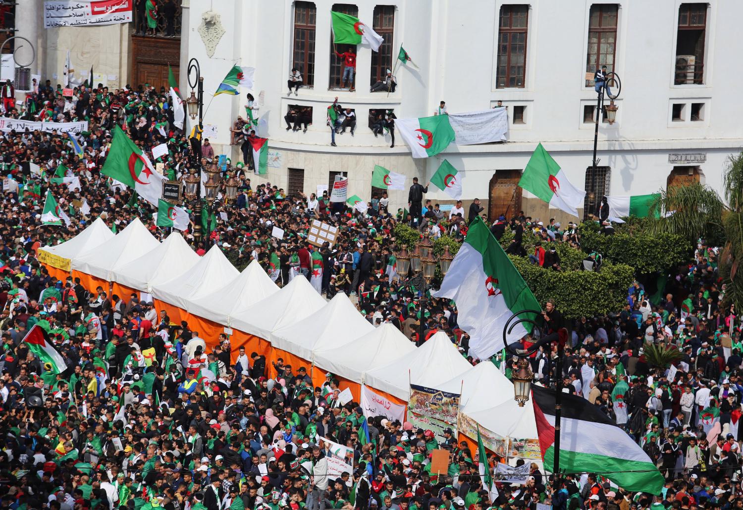 People carry flags during a protest demanding radical change in Algiers, Algeria April 5, 2019