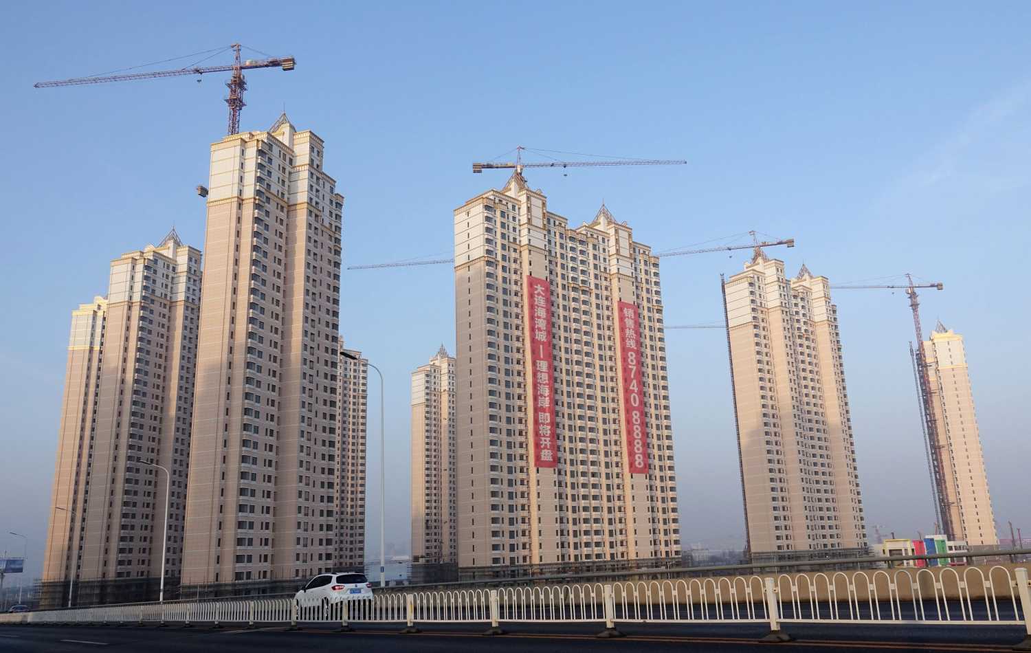 Residential buildings under construction are seen in Jinpu New District in Dalian, Liaoning province, China March 19, 2018. China Daily via REUTERS   ATTENTION EDITORS - THIS IMAGE WAS PROVIDED BY A THIRD PARTY. CHINA OUT. NO COMMERCIAL OR EDITORIAL SALES IN CHINA. - RC16EF764510