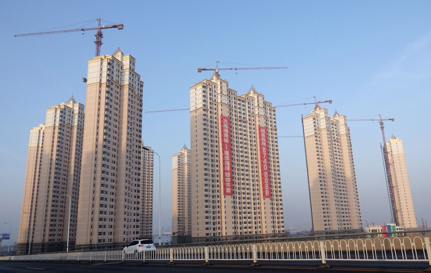 Residential buildings under construction are seen in Jinpu New District in Dalian, Liaoning province, China March 19, 2018. China Daily via REUTERS   ATTENTION EDITORS - THIS IMAGE WAS PROVIDED BY A THIRD PARTY. CHINA OUT. NO COMMERCIAL OR EDITORIAL SALES IN CHINA. - RC16EF764510