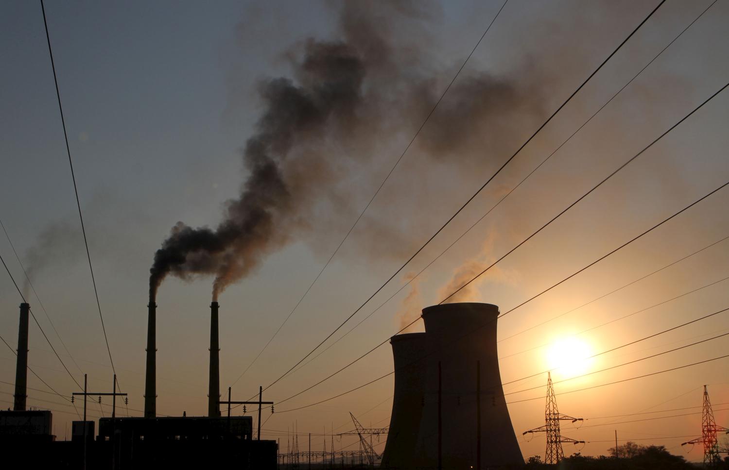 Cooling towers are seen at a coal fired power station in Hwange, Zimbabwe September 28, 2015. The plant, one of the country's biggest electricity generating units, is back online after annual routine maintenance at the start of this month led to severe power cuts in the southern African nation. Picture taken September 28, 2015.   REUTERS/Philimon Bulawayo  - GF10000226045