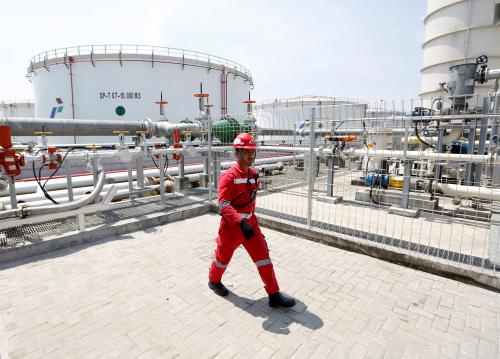 A man walks near storage tanks at a state-owned Pertamina fuel depot in Jakarta, Indonesia, May 8, 2018. REUTERS/Willy Kurniawan - RC187A6D7BD0