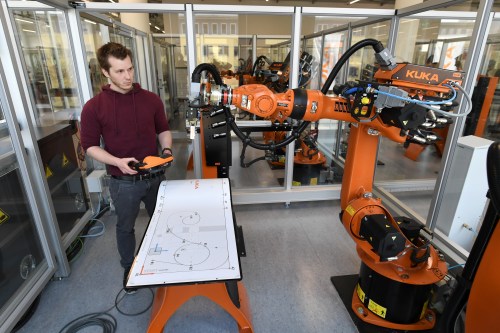 Bastian Remmel, an employee of German manufacturer of industrial robots and automation solutions KUKA, poses for pictures at the company's training center in Augsburg, Germany, March 28, 2019. REUTERS/Andreas Gebert - RC195B733B00