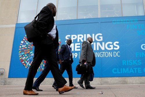 Delegates walk outside the International Monetary Fund headquarters building ahead of the IMF/World Bank spring meetings in Washington, U.S., April 8, 2019. REUTERS/Yuri Gripas - RC17038BDDE0