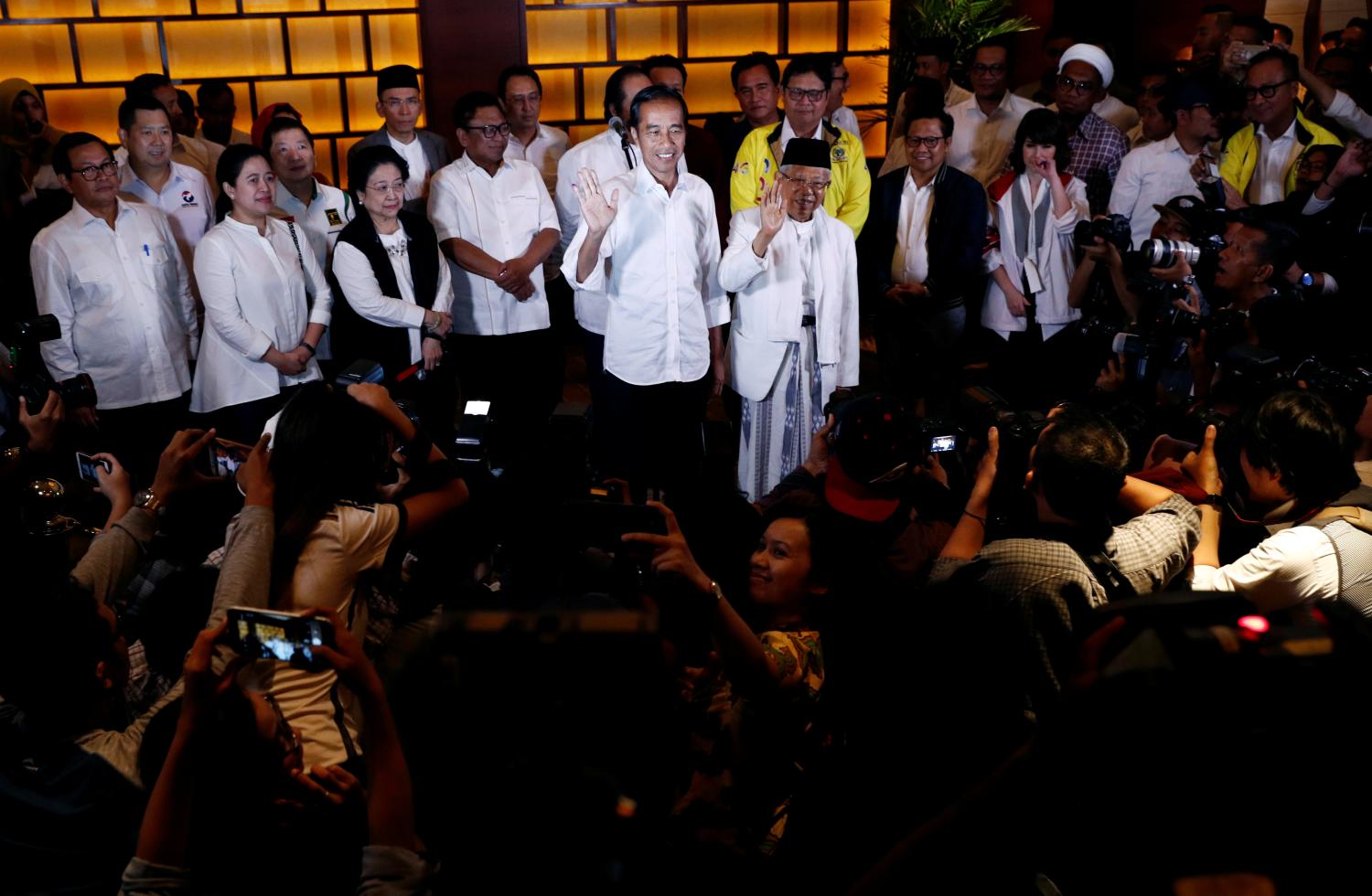 Indonesia's President Joko Widodo and his running mate Ma'ruf Amin react after a quick count result during the Indonesian elections in Jakarta, Indonesia April 17, 2019. REUTERS/Edgar Su - RC19421D72E0