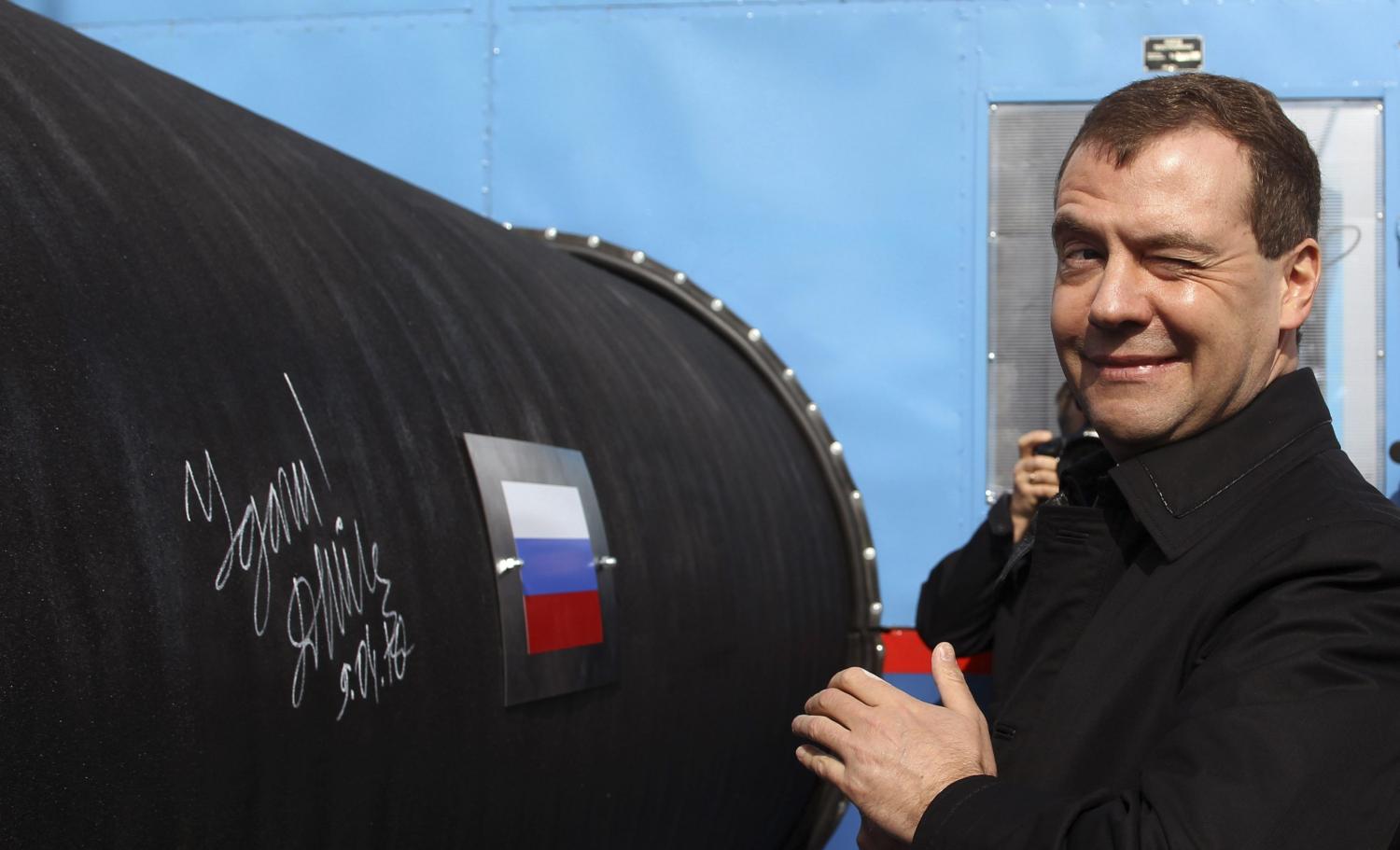 Russian President Dmitry Medvedev gestures after writing 'Good Luck!' on a pipe of the Nord Stream pipeline near Russian town of Vyborg, April 9, 2010. Medvedev took part in the ceremony on Friday to start building the pipeline, which was designed to help Russia increase its influence in EU gas markets from the current 25 percent to about a third.  REUTERS/Alexander Demianchuk  (RUSSIA - Tags: POLITICS ENERGY BUSINESS) - GM1E6491EYC01