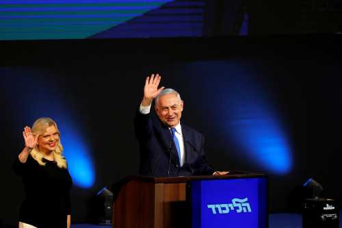 Israeli Prime Minister Benjamin Netanyahu and his wife Sara react as they stand on stage following the announcement of exit polls in Israel's parliamentary election at the party headquarters in Tel Aviv, Israel April 10, 2019. REUTERS/Ronen Zvulun - RC1262B7EBB0