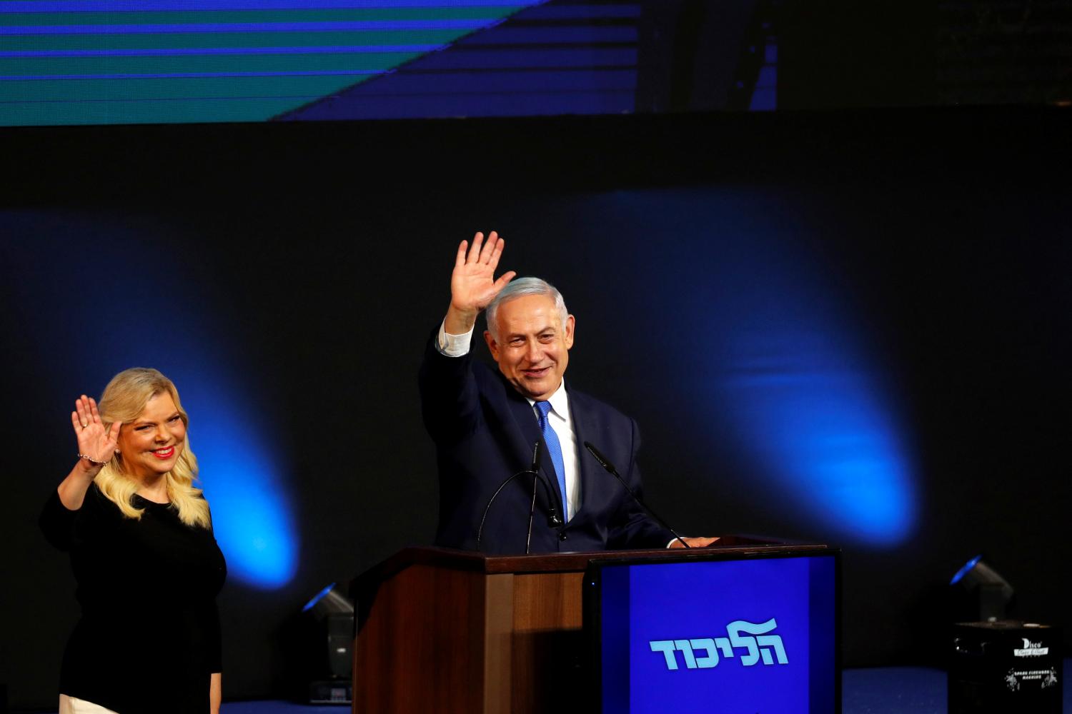 Israeli Prime Minister Benjamin Netanyahu and his wife Sara react as they stand on stage following the announcement of exit polls in Israel's parliamentary election at the party headquarters in Tel Aviv, Israel April 10, 2019. REUTERS/Ronen Zvulun - RC1262B7EBB0