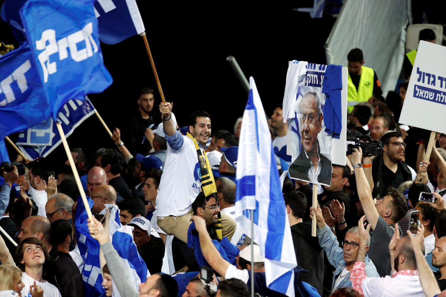 Supporters of Israeli Prime Minister Benjamin Netanyahu's Likud party react to exit polls in Israel's parliamentary election at the party headquarters in Tel Aviv, Israel April 10, 2019. REUTERS/Ronen Zvulun - RC1E78CE7370