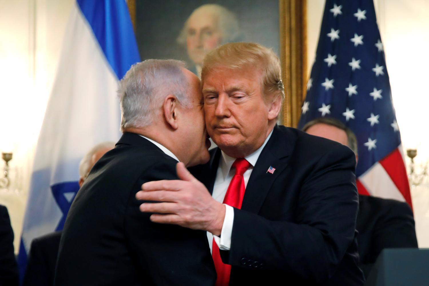 Israel's Prime Minister Benjamin Netanyahu hugs U.S. President Donald Trump as they talk during meetings at the White House in Washington, U.S., March 25, 2019. REUTERS/Carlos Barria - RC15FD644460