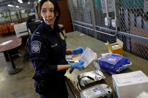 DATE IMPORTED: July 11, 2018 U.S. Customs and Border Protection officer Ella Olejnik looks at the paperwork on a package before inspecting the substance inside at the International Mail Facility at O'Hare International Airport in Chicago, Illinois, U.S. November 29, 2017. Picture taken November 29, 2017. REUTERS/Joshua Lott