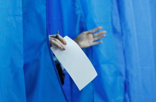 A voter holds a ballot while walking out of a booth at a polling station during the second round of a presidential election in Kiev, Ukraine April 21, 2019. REUTERS/Valentyn Ogirenko - RC1248C64FB0