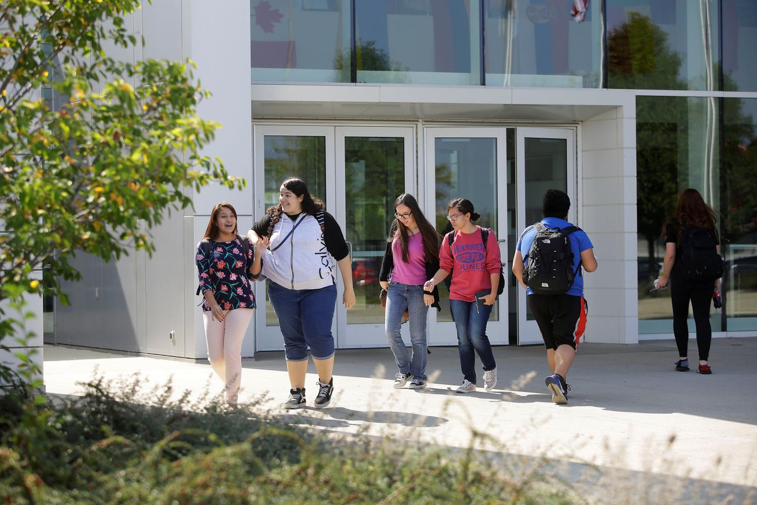 People walk along the campus of DeVry University in Chicago, Illinois, U.S., September 20, 2017. Picture taken September 20, 2017. REUTERS/Joshua Lott - RC1C82D5DD30