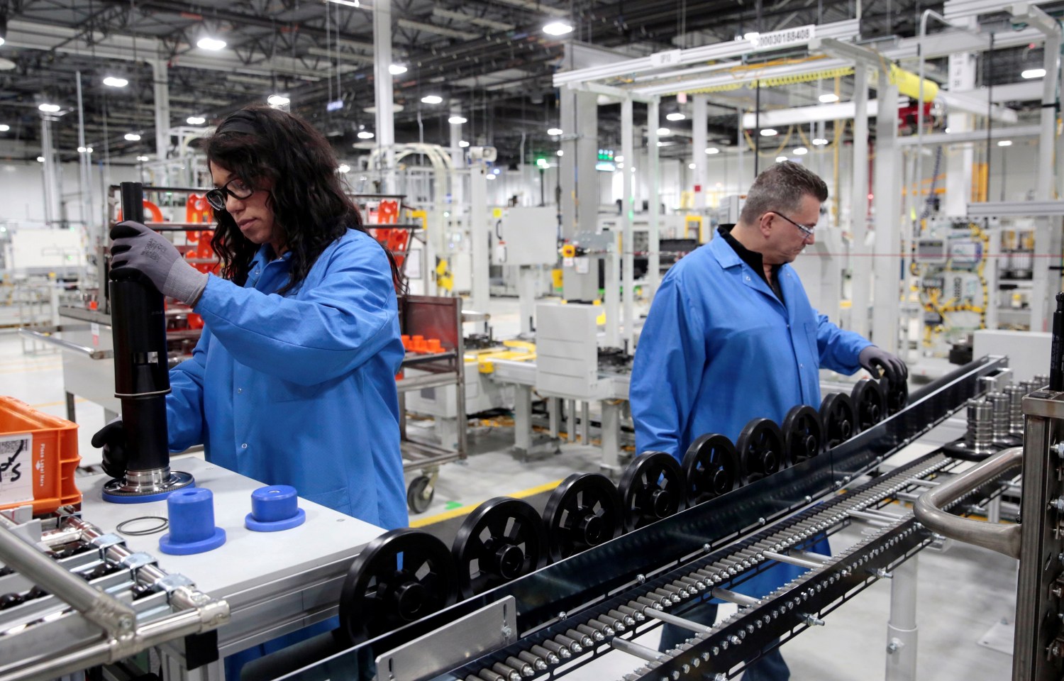 General Motors production workers Dina Mays and Joseph Stanton work on the 10-speed transmission assembly at the General Motors (GM) Powertrain Transmission plant in Toledo, Ohio, U.S. March 6, 2019. Picture taken March 6, 2019.  REUTERS/Rebecca Cook - RC18171696D0