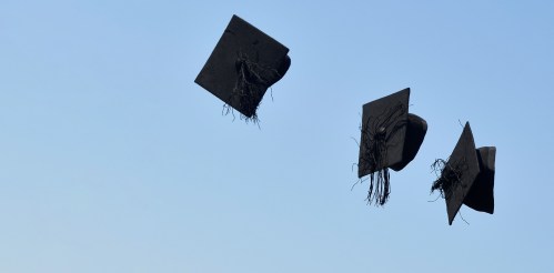 'Mortar board' hats are thrown in the air following a graduation ceremony for students at University of Brighton in Brighton, southern Britain, August 3, 2018. REUTERS/Toby Melville - RC17F2A09540