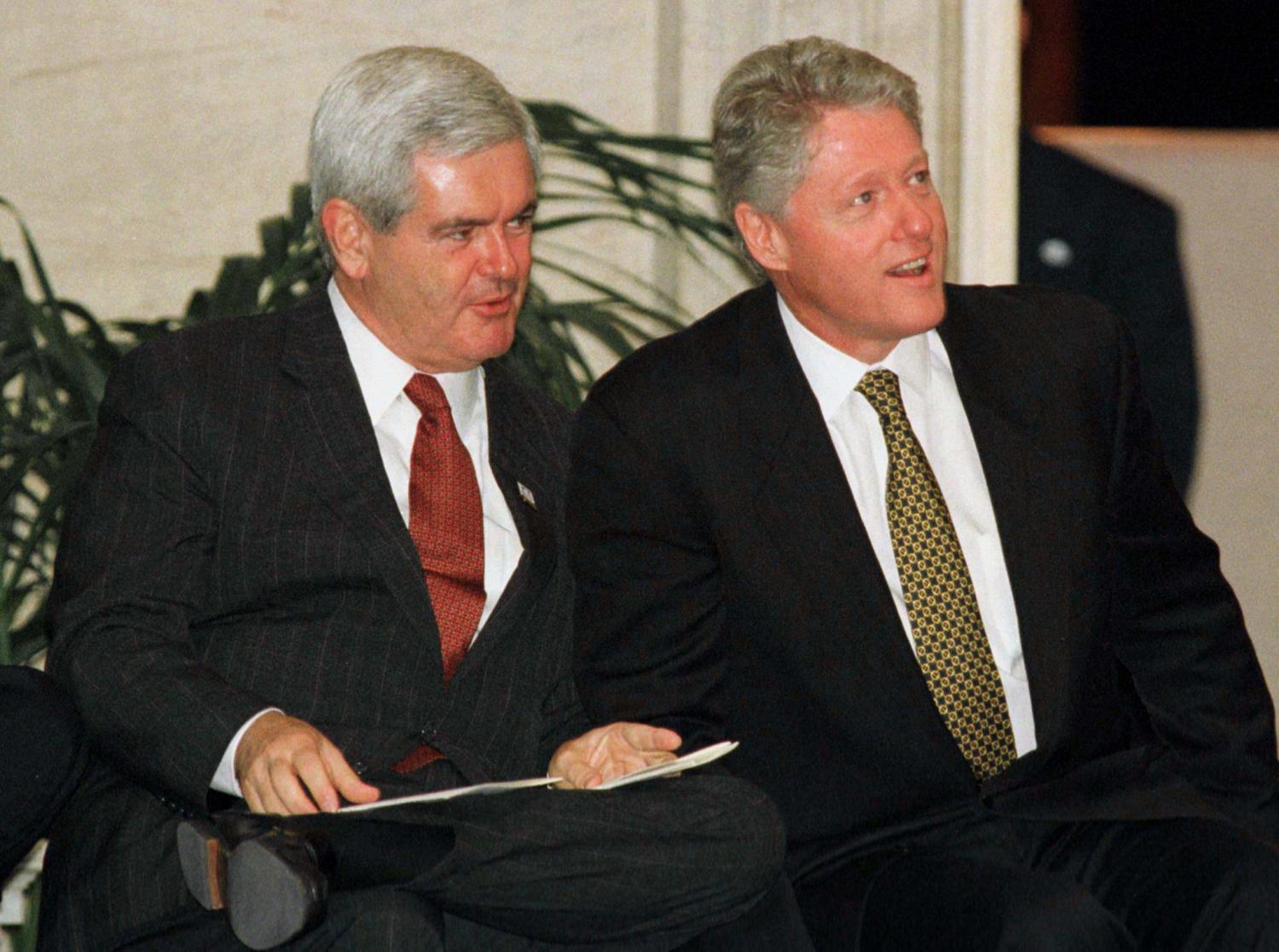 U.S. House of Representatives Speaker Newt Gingrich (L) and President Bill Clinton sit during ceremonies at the U.S. Capitol [honouring South African President Nelson Mandela] September 23. Gingrich said earlier that it was too early to talk of compromise with the White House and that the impeachment investigation of Clinton should continue. - PBEAHUMGBCS