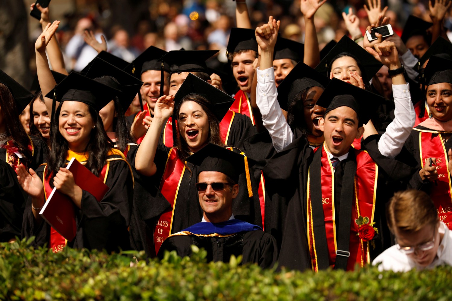 Graduates celebrate during the commencement ceremony at the University of Southern California (USC) in Los Angeles, California, U.S., May 12, 2017. REUTERS/Patrick T. Fallon - RC1EA96FB0C0
