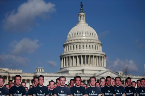 Dozens of cardboard cut-outs of Facebook CEO Mark Zuckerberg sit outside of the U.S. Capitol Building as part of an Avaaz.org protest in Washington, U.S., April 10, 2018. REUTERS/Leah Millis - RC1CA8A95B60