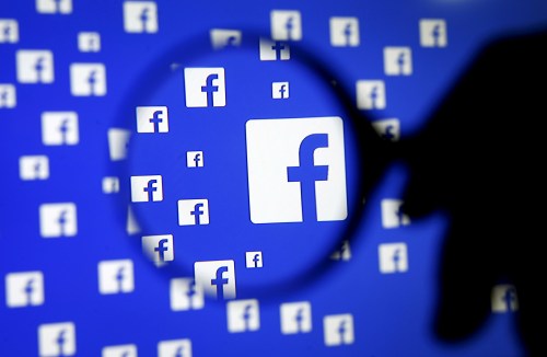 FILE PHOTO: A man poses with a magnifier in front of a Facebook logo on display in this illustration taken in Sarajevo, Bosnia and Herzegovina, December 16, 2015.   REUTERS/Dado Ruvic/Illustration/File Photo - RC15EFBD74F0
