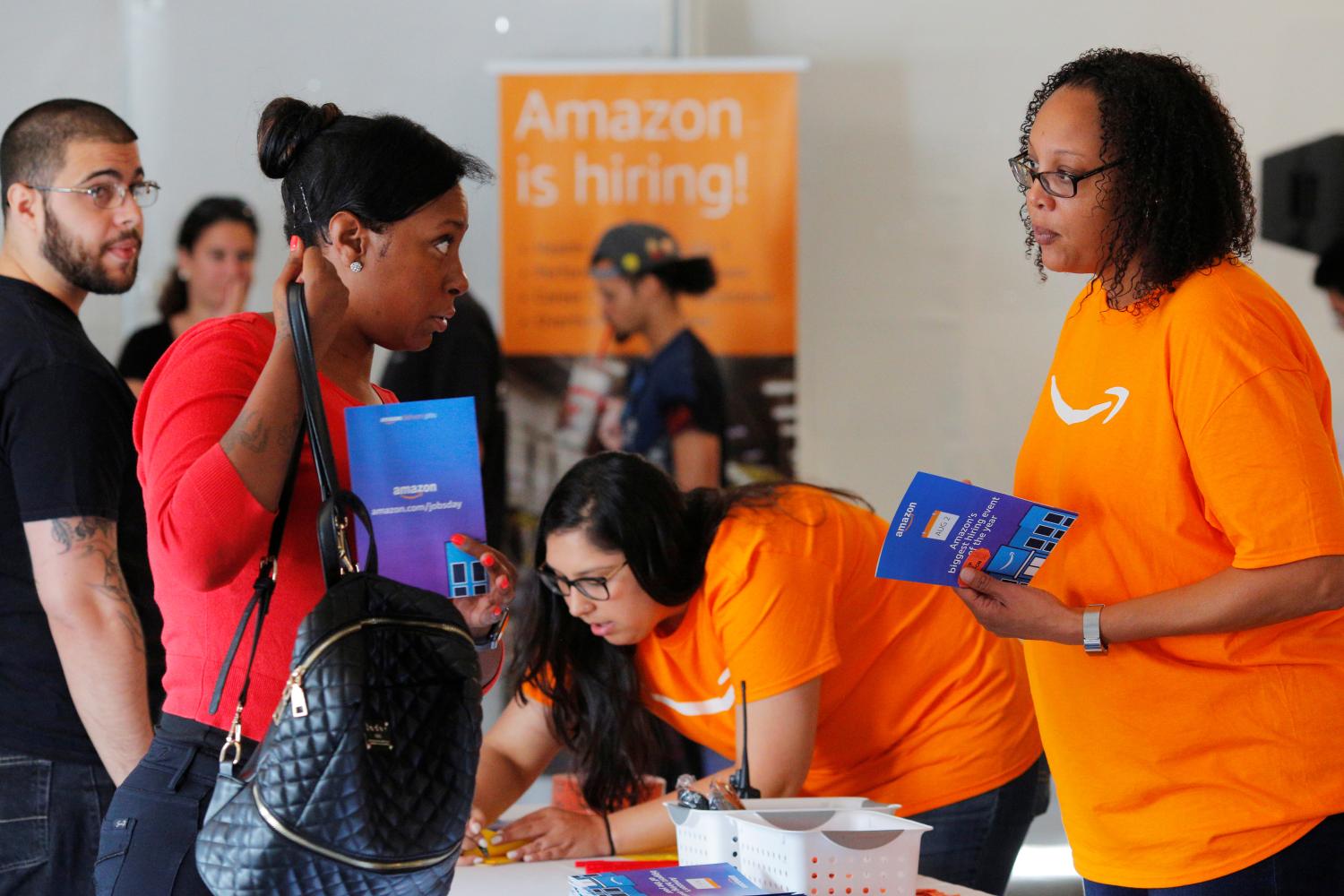 Potential job applicants register for "Amazon Jobs Day," a job fair being held at 10 fulfillment centers across the United States aimed at filling more than 50,000 jobs, at the Amazon.com Fulfillment Center in Fall River, Massachusetts, U.S., August 2, 2017.   REUTERS/Brian Snyder - RC19CB5C0CE0