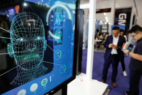 Visitors check their phones behind the screen advertising facial recognition software during Global Mobile Internet Conference (GMIC) at the National Convention in Beijing, China April 27, 2018. REUTERS/Damir Sagolj - RC1838EC3EA0