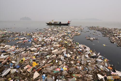 A boy rows his boat in the polluted waters of the Brahmaputra river on the occasion of World Water Day in Guwahati, India, March 22, 2018. REUTERS/Anuwar Hazarika - RC14A5D8FB60