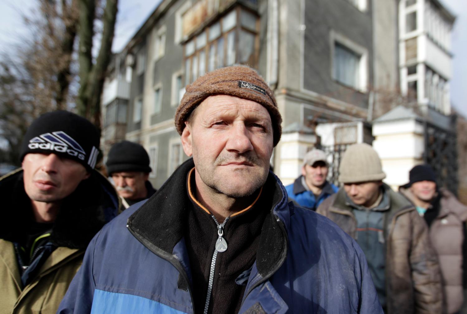 Men attend a charity event to distribute meals for homeless people near a cathedral in Russia's southern city of Stavropol November 19, 2014. The charity event was organized by social movements, the Russian Orthodox church and held by former drug and alcohol addicts undergoing rehabilitation, who cooked and distributed food among the homeless, according to organizers. REUTERS/Eduard Korniyenko (RUSSIA - Tags: SOCIETY FOOD POVERTY) - GM1EABJ1C3W01