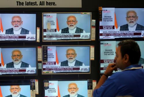 A man watches Prime Minister Narendra Modi addressing to the nation, on TV screens inside a showroom in Mumbai, India, March 27, 2019. REUTERS/Francis Mascarenhas - RC1B207CBD20