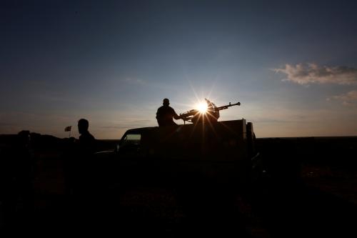 A Popular Mobilisation Forces (PMF) fighter rides in a military vehicle at the Iraqi-Syrian border near al-Qaim, Iraq, November 26, 2018. Picture taken November 26, 2018. REUTERS/Alaa al-Marjani - RC13847779F0