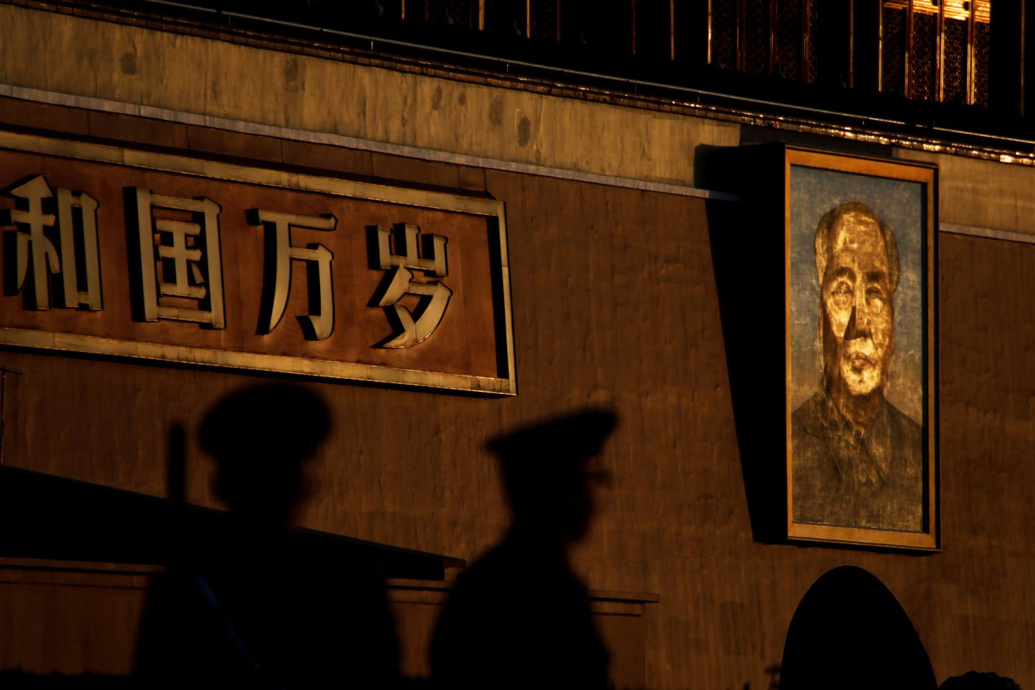 Paramilitary policemen stand guard at sunrise in front of a giant portrait of late Chinese Chairman Mao Zedong at the Tiananmen gate ahead of the visit by U.S. President Donald Trump to Beijing, China November 8, 2017. REUTERS/Damir Sagolj     TPX IMAGES OF THE DAY - RC1B1195C290