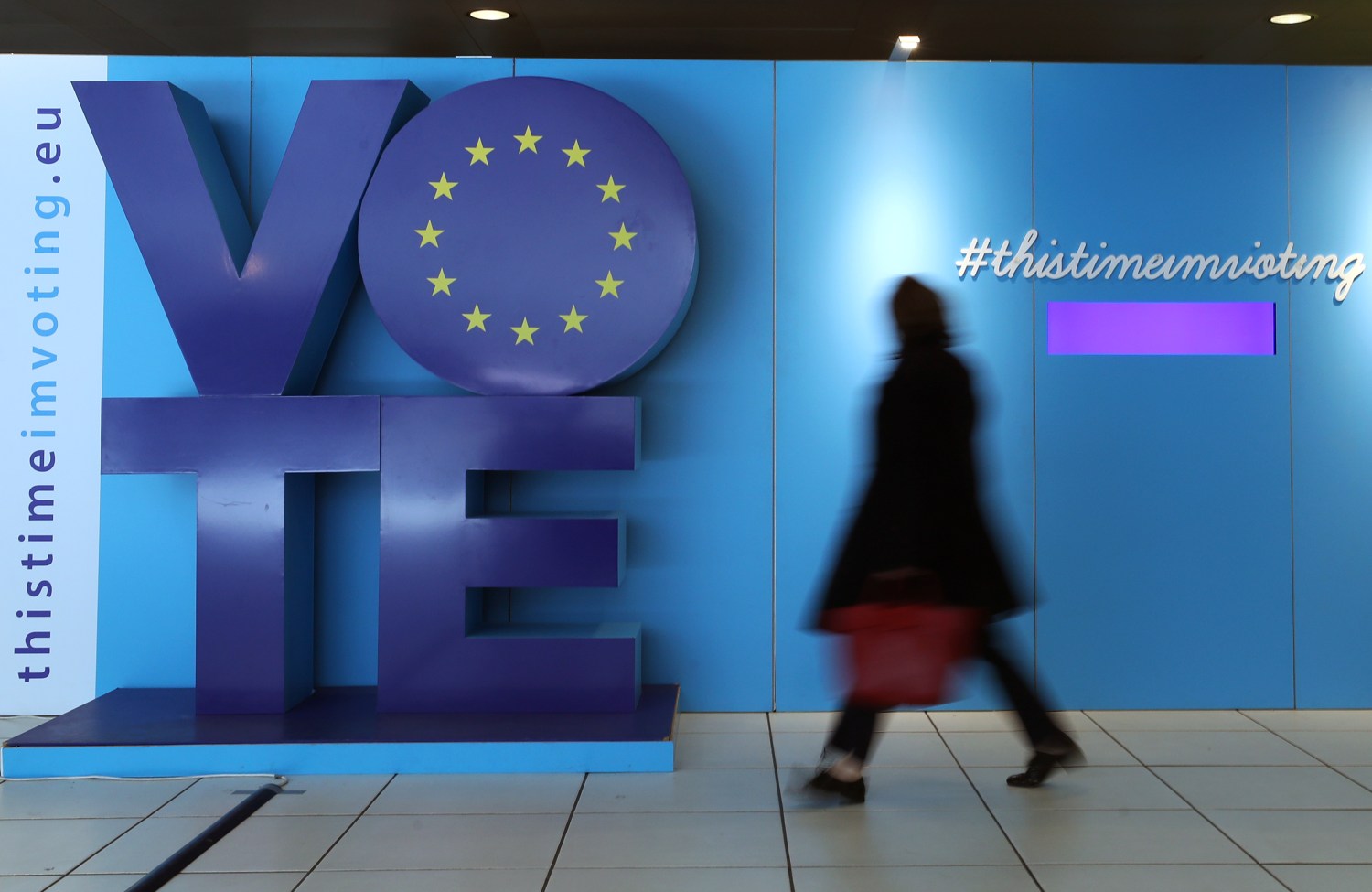 A woman walks past an advertising board for the EU elections at the Schuman railway station near the European Parliament in Brussels, Belgium, May 22, 2019. REUTERS/Yves Herman - RC1471A03120