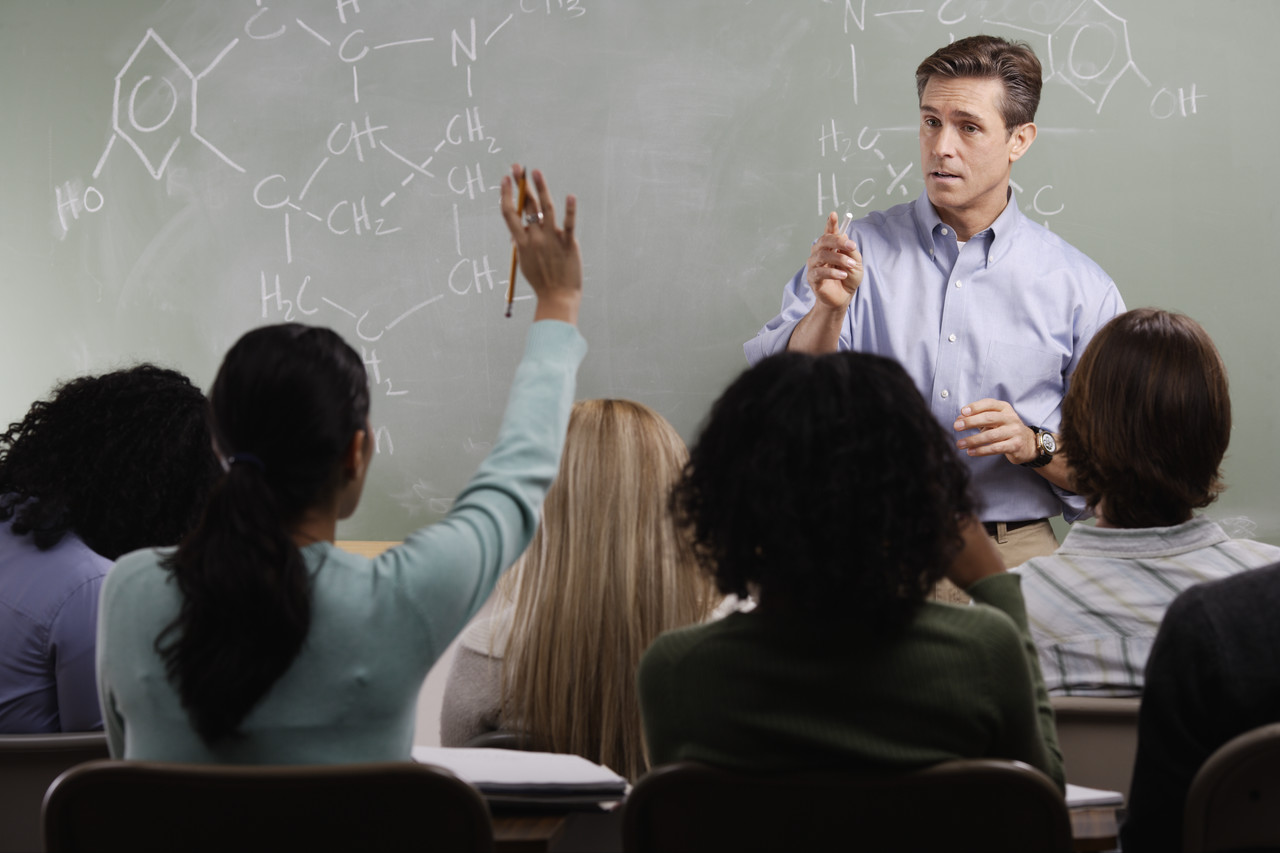 Chemistry Teacher with Students in Class --- Image by © Royalty-Free/Corbis