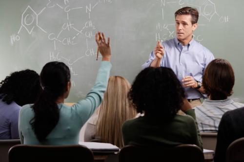 Chemistry Teacher with Students in Class --- Image by © Royalty-Free/Corbis