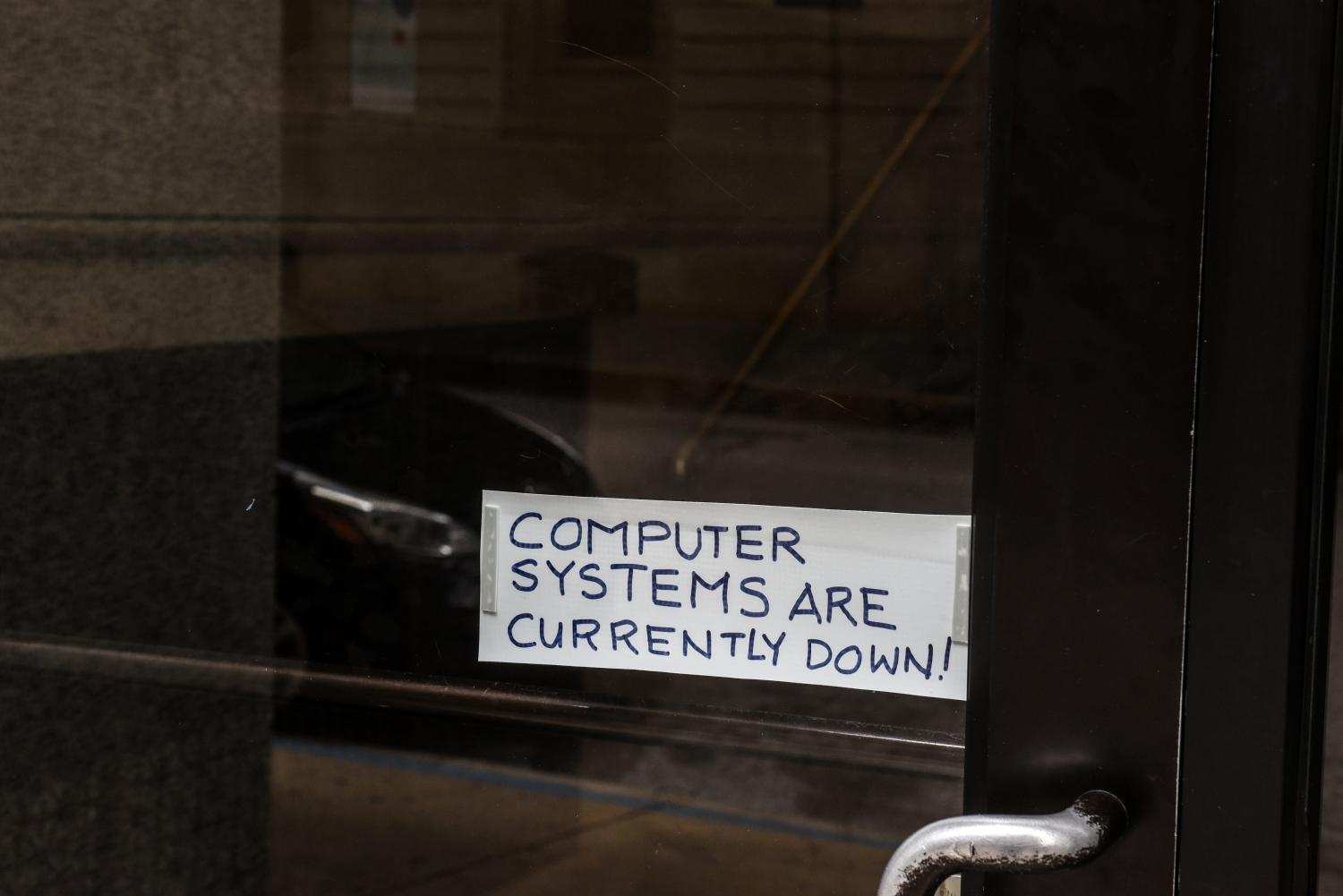 A sign referring to the hacked computer system of Baltimore City is taped to a door near Baltimore City Hall in Baltimore, Maryland, U.S. May 10, 2019. REUTERS/Stephanie Keith - RC1616204E00