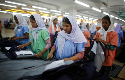 Workers sort clothes at a garment factory near the collapsed Rana Plaza building in Savar June 16, 2013. The April 24 collapse of the Rana Plaza complex, built on swampy ground outside Dhaka with several illegal floors, killed 1,132 workers and focused international attention on sometimes lax safety standards in Bangladesh's booming garment industry. At least five different Bangladesh agencies have dispatched teams to start inspecting the country's thousands of garment factories, but there has been little coordination between them. More than four million people, mostly women, work in Bangladesh's clothing sector, which is the country's largest employment generator, with annual exports worth $21 billion. Picture taken June 16, 2013. REUTERS/Andrew Biraj (BANGLADESH - Tags: DISASTER BUSINESS EMPLOYMENT TEXTILE) - GM1E97T1MVQ01